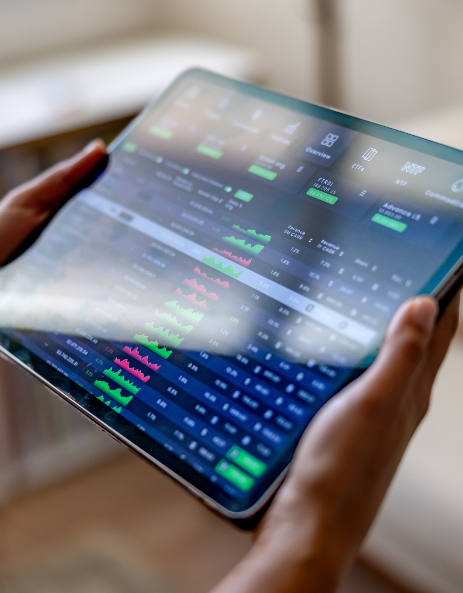 Close‑up of a tablet showing stock charts, price movements and financial data dashboards